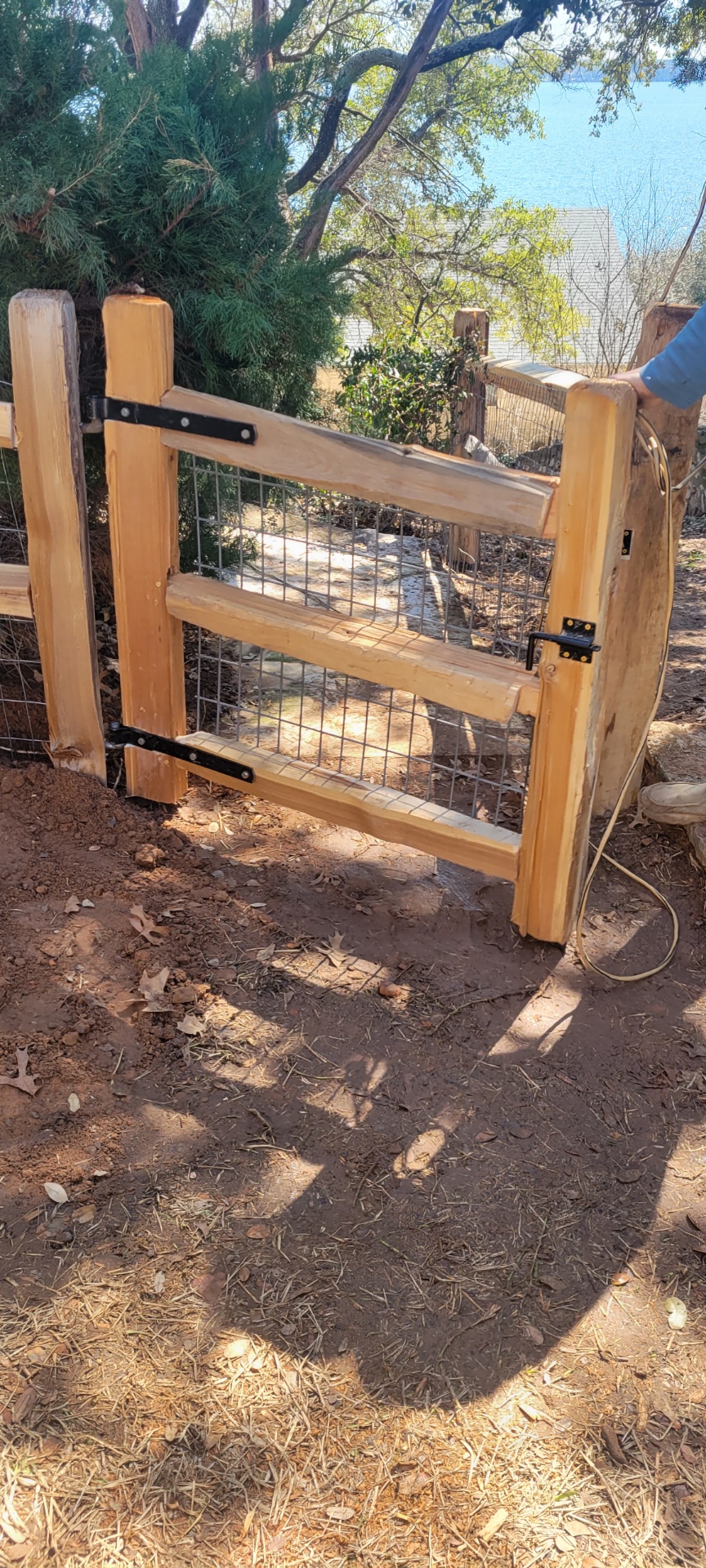Cedar wood and wire gate built and installed on a rural Hood County property