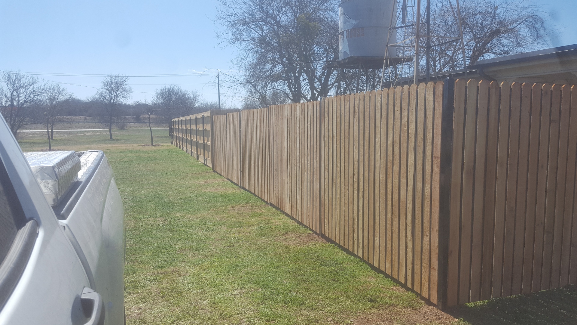 Cedar shadowbox picket fence installed on a residential lot in Hood County