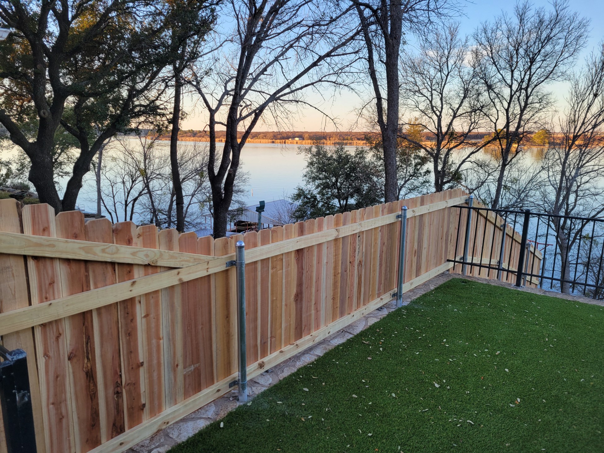 New cedar privacy fence installed on a Lake Granbury-area residential property