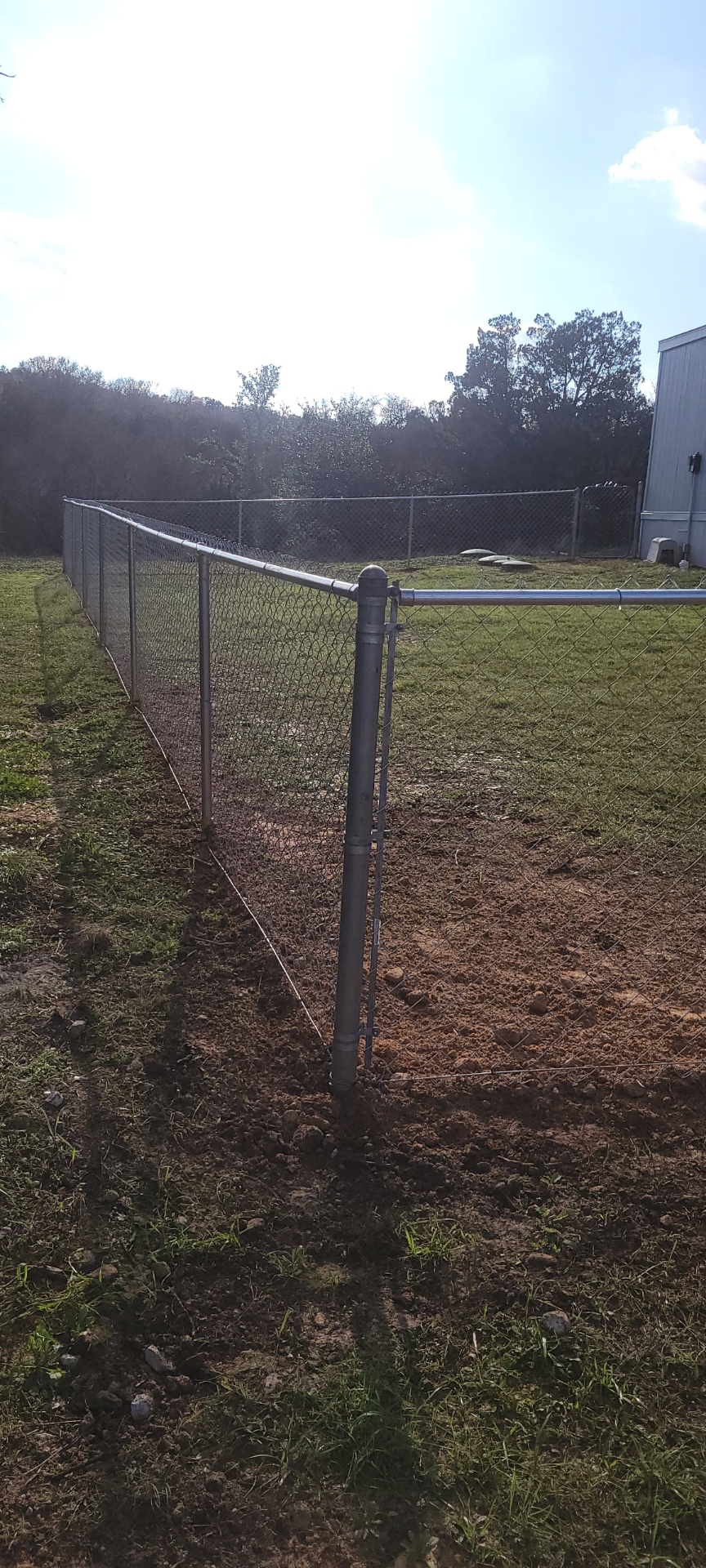 Galvanized chain link fence enclosing an open yard on a Hood County property